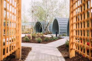 a garden through the fence of a building at Let's Go Hydro Resort & Spa in Carryduff