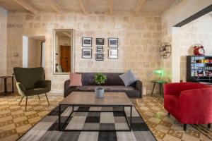 a living room with a couch and a table and chairs at Chic, Stylish & Spacious flat in central Valletta in Valletta