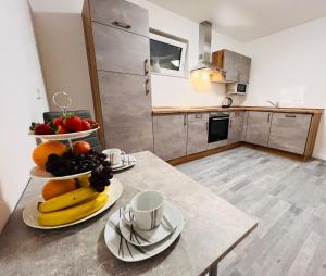 a kitchen with a table with a bowl of fruit on it at Apartment Weikersheim I in Weikersheim