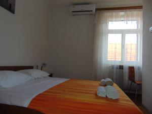 a bedroom with a bed with two towels on it at MARINA Apartment end rooms in Vela Luka