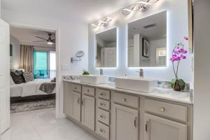 a bathroom with two sinks and a large mirror at Gorgeous Oceanview 3BR Luxury Condo - Latitude in Gulfport