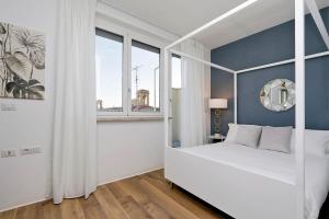 Postel nebo postele na pokoji v ubytování La Flavia Design City Suites Rome by Halldis