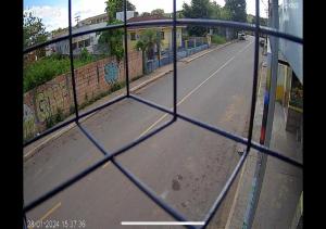 a view of an empty street through a fence at Residencial Margarida APART 4 in Presidente Figueiredo