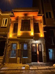 a house with lights on the front of it at night at NarPera Taksim Boutique Hotel in Istanbul