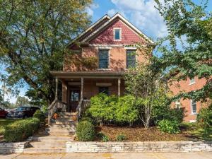 an old brick house with a tree at Housepitality - The Victorian Vacation Home in Columbus