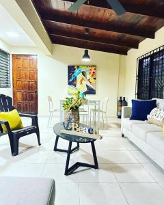 a living room with a couch and a table at LA CASA DE MAMA LUZ in San Felipe de Puerto Plata