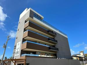 a tall building with a blue sky in the background at Pousada Atlantic in Porto De Galinhas