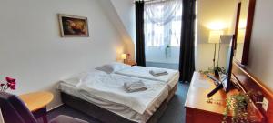 Ένα ή περισσότερα κρεβάτια σε δωμάτιο στο Hotel Magnolia