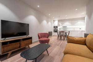 a living room with a large flat screen tv at The Sessile in London