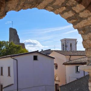 a view of a building and a church from a window at Al Piccolo Borgo Locanda Con Alloggio in Castelnuovo Parano