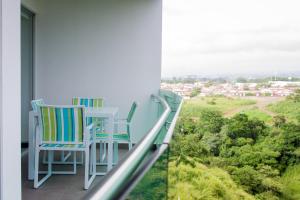 two chairs on a balcony with a view of a city at Charming two bedroom apartment in San José