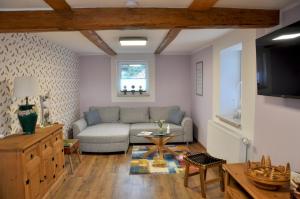 a living room with a couch and a table at Ferienhaus Am Mühlenberg Thale Westerhausen in Thale