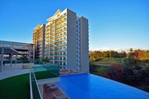 a building with a swimming pool in front of a building at Charming two bedroom apartment in San José