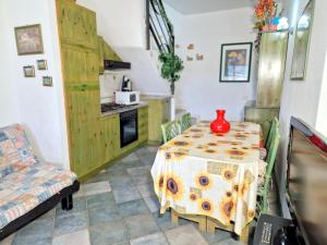 a kitchen with a table with a vase on it at La Terrazza in Villasimius