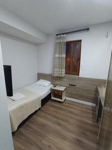 A bed or beds in a room at Dara otel