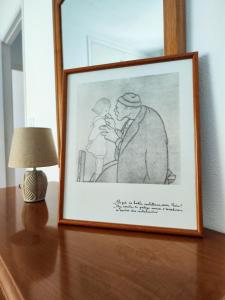 a drawing of a man holding a child on a table at Apartamento Pena Furada in Ribadeo