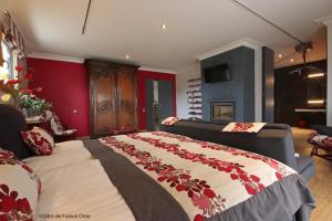 a bedroom with a large bed and a couch at Lyolyl BnB in Sainte-Croix-sur-Orne