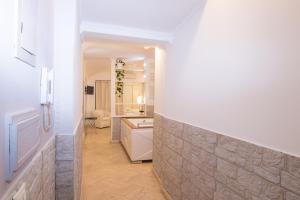 a room with a stone wall and a bathroom at Deluxe Suite Welness in Rome