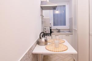 a kitchen with two plates and a tea kettle on a counter at Deluxe Suite Welness in Rome