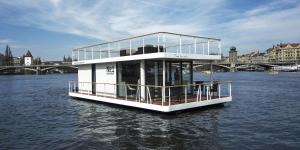 a house boat in the water on a river at VIPliving Houseboat in Prague