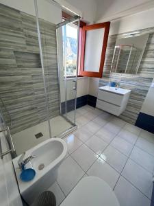 a bathroom with a sink and a shower at Yucca Apartment in San Vito lo Capo