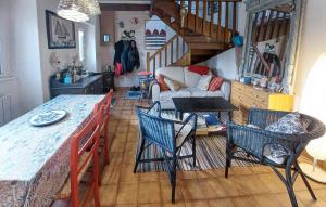 a living room with a table and chairs at 2 Bedroom Lovely Home In Pleumeur-Bodou in Pleumeur-Bodou