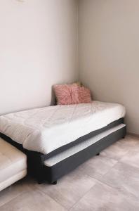 a bed sitting in a corner of a room at Mi casa es tu casa!! in Malargüe