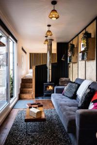 a living room with a couch and a fireplace at The Hideaways in Exeter