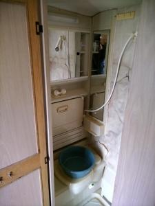 a small bathroom with a toilet and a mirror at Каравана под наем с невероятна морска панорама in Balchik