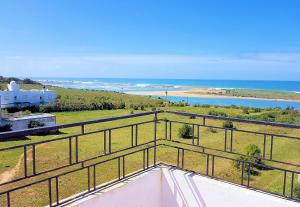 a view of the ocean from the balcony of a house at Maison de la Lagune in Oualidia