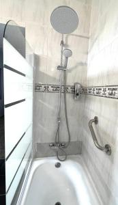 a bath tub with a shower in a bathroom at Casa Vacacional Bevi - Tenerife Norte in Los Realejos +67 photos