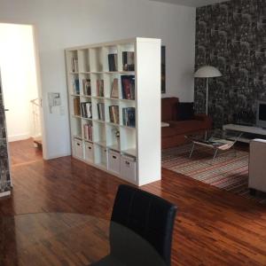 a living room with a book shelf filled with books at Belong Staying and Feeling - Casa da Sé in Lisbon