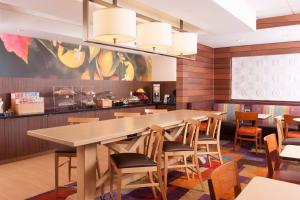 a dining room with a large table and chairs at Fairfield Inn Charlotte Gastonia in Gastonia