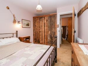 a bedroom with a bed and a wooden door at Eden Vale in Broughton in Furness