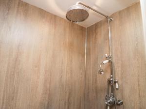 a shower in a bathroom with a wooden wall at Eden Vale in Broughton in Furness +47 photos