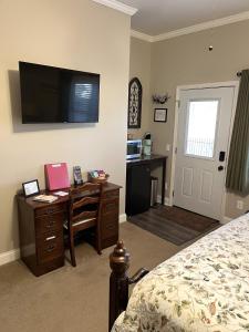 a bedroom with a desk and a bed and a television at Stay at Rivermist Dahlonega in Dahlonega