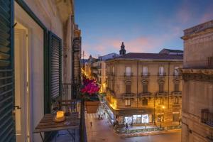 a balcony with a view of a city at night at 70 Lab Apartment in Palermo