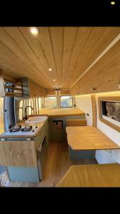 a kitchen in an rv with a table and a stove at Furgoneta camperizada in Playa de las Americas