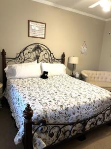 a bedroom with a bed with a black cat sitting on it at Stay at Rivermist Dahlonega in Dahlonega