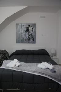 a bedroom with a bed with two towels on it at IL BORGO in Quattromiglia