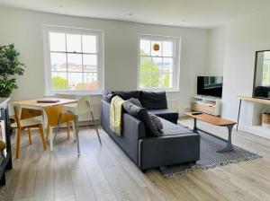 a living room with a couch and a table at Apartment 4 St Georges in Cheltenham