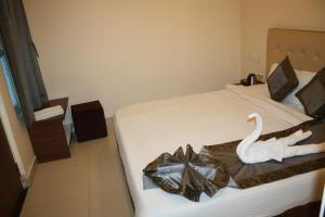 a hotel room with a bed with a swan on it at Raghunath Palace Home Stay in Varanasi
