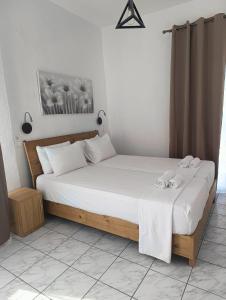 a bedroom with a bed with two shoes on it at Galini Apartments in Balíon