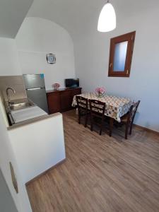 a kitchen and dining room with a table and a sink at Appartamenti Di Iorio in Ischia