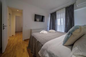 Posteľ alebo postele v izbe v ubytovaní Faliro Lux Apartment By The Sea VIPGreece