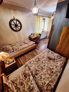 a room with two beds and a table with a desk at Karkonoska Drewniana Chata in Kamienna Góra