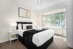 Un dormitorio con una cama grande y una ventana en Luxury 3 Bed House - Parking - Garden - Pool Table -782S, en Birmingham