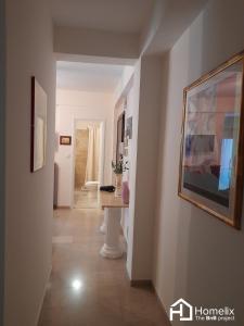 a hallway with a table and a picture on the wall at Dimora in Chalkida