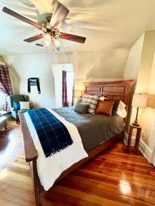 a bedroom with a bed with a ceiling fan at MacFie House in Cape Girardeau