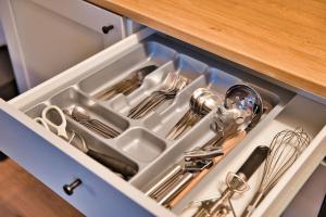 a drawer filled with silver utensils in a cabinet at Apartment im Herzen Bochums (1km zum Hauptbahnhof) in Bochum